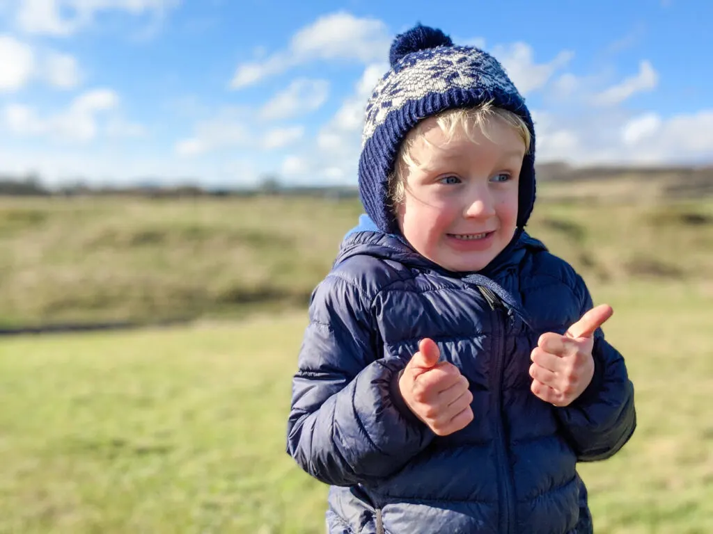 thumbs up on a winter walk